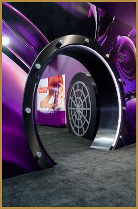 A futuristic circular doorway with metallic and purple accents leads to a room with a large graphic of a person’s legs and feet on the wall. Description generated by AI